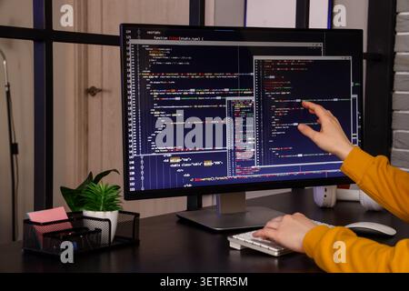 Female programmers hands working with computer at table in office Stock Photo