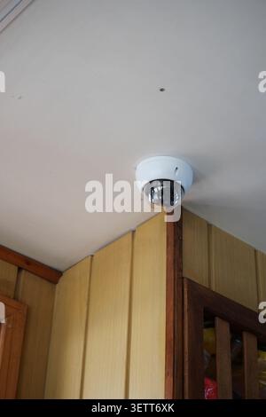 Security camera installed in building corner for safety Stock Photo