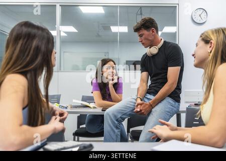 Young students are engaging in collaborative learning, sharing ideas, and having a group discussion in a modern university classroom setting, fosterin Stock Photo