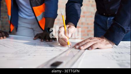 Hands, blueprint and drawing at construction site for engineer, teamwork or urban infrastructure. Architect people, paperwork and floor plan for Stock Photo