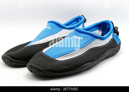 A Pair of blue and black water shoes with white mesh for swimming isolated on white background. Stock Photo