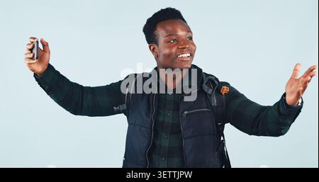 Student, black man or video call with phone in studio for education vlog, social media or smile. Virtual chat, college and happy person on mobile for Stock Photo