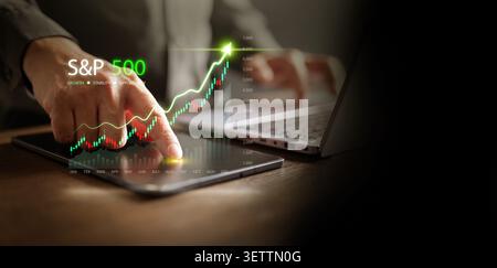 S and P 500 stock market chart displayed on tablet with finger touch interaction on dark copy space. Mobile trading, fintech investment analysis, fina Stock Photo
