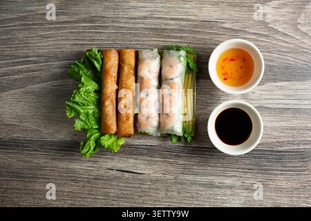 A top down view of a plate of egg rolls and shrimp spring rolls. Stock Photo