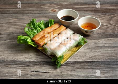 A view of a plate of egg rolls and shrimp spring rolls. Stock Photo