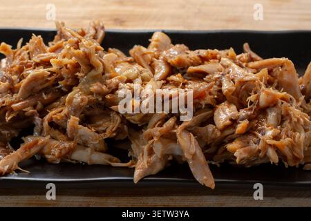 A view of a plate of crockpot BBQ chicken. Stock Photo