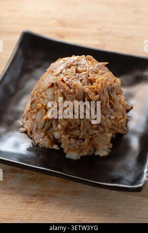 A view of a molded pile of crockpot BBQ chicken on a plate. Stock Photo