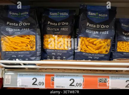 DENIA, SPAIN - January 26, 2026.Bags of Sam Mills Pasta d'Oro gluten free corn pasta in penne and fusilli shapes are displayed on a supermarket shelf Stock Photo
