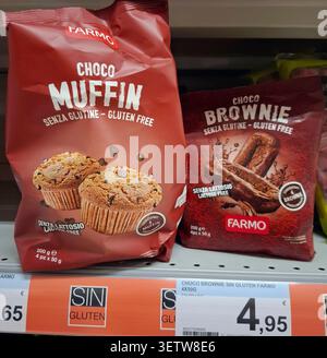 DENIA, SPAIN - January 26, 2026.Farmo brand gluten free chocolate muffins and brownies are arranged on a supermarket shelf in Spain. Customers can eas Stock Photo