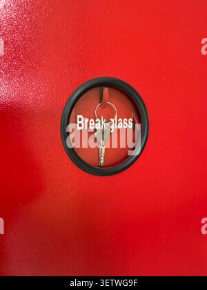 break glass emergency key box on red metal door, close-up soft focus view with copy space, fire safety security concept Stock Photo