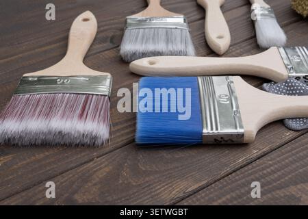 Painting equipment arranged on a wooden background including brushes Stock Photo