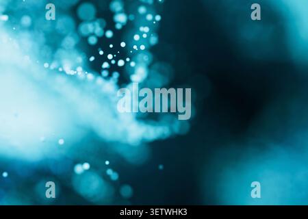 Abstract blue background with glowing light particles and soft bokeh effect. Futuristic digital wave concept, perfect for technology, science, and mod Stock Photo