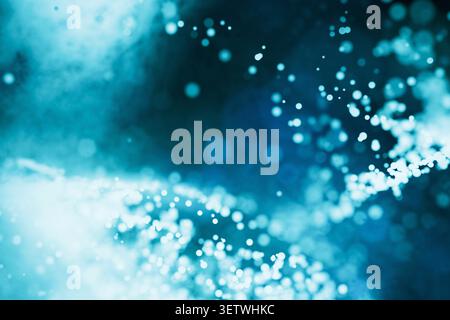Abstract blue digital background with floating light particles and soft bokeh. Features a dynamic glowing wave structure, ideal for technology, networ Stock Photo