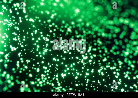 Abstract green background filled with a dense overlay of sharp and blurred glowing bokeh particles. Ideal for digital technology, matrix concepts, sci Stock Photo