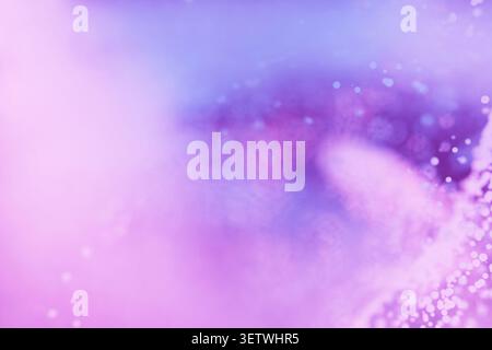 An abstract dreamy background in soft purple, pink, and violet tones with a gentle bokeh light effect, blurred textures, and a magical ethereal atmosp Stock Photo