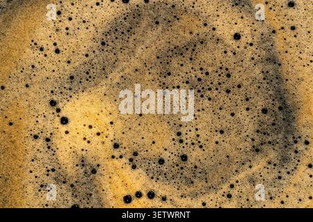 Coffee foam texture background espresso crema macro close up. Detailed macro shot of fresh espresso coffee foam texture with thousands of small bubble Stock Photo
