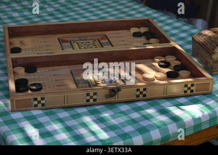 A Lebanese backgammon board, tawle, placed on a green checkered table cover. Stock Photo