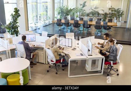 Finance analysts team working on data reports at modern open plan office Stock Photo