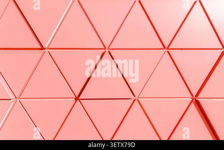 Geometric facade texture with triangular panels forming abstract pattern. Architectural surface shows repeating shapes and linear structure. Concept o Stock Photo