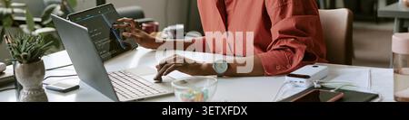 Header of Black Woman Coding on Laptop and Tablet Stock Photo