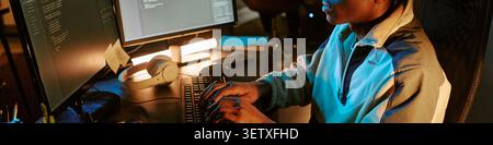 Header of Black Man Developing Software at Computer during Night Shift Stock Photo