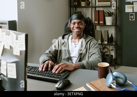 Portrait of Black Man Working at Computer in Modern Office Stock Photo