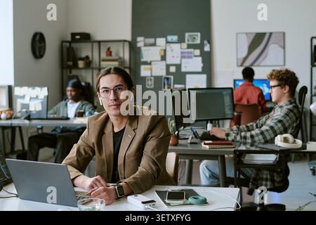 Portrait of Adult Man Working in Creative Office Team Environment Stock Photo