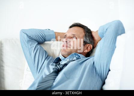 Relax, happy and businessman in home with completed project for investment report with remote work. Calm, professional and male financial manager on Stock Photo