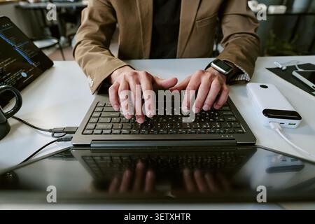 Adult Man Typing on Laptop for Software Development Work Stock Photo