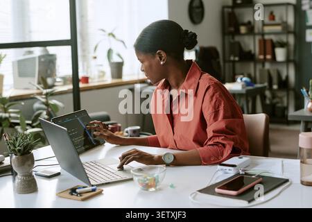 Black Woman Developer Working on Coding Project in Office Stock Photo