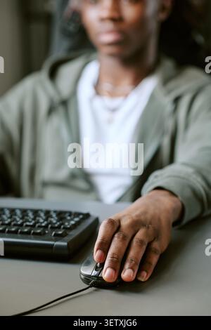 Unrecognizable Man Using Computer Mouse for Online Learning Stock Photo