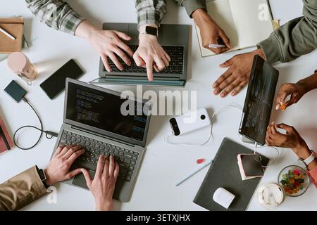 Diverse Team Collaborating on Software Development at Workspace Stock Photo