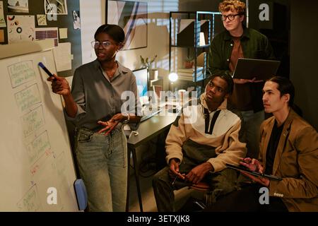 Black Woman Leading Creative Team Brainstorming in Office Stock Photo