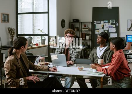 Diverse Coworkers Collaborating in Office Strategy Meeting Stock Photo