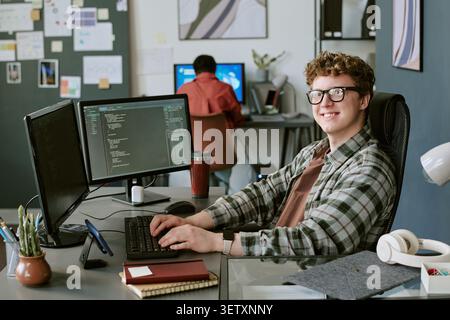 Portrait of Man Coding at Startup Office Workspace Stock Photo