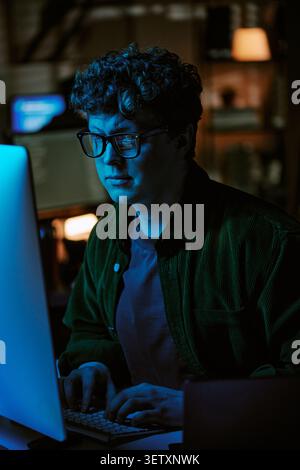 Adult Man Working on Desktop Computer in Night Office Stock Photo