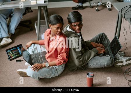 Black Colleagues Collaborating on Coding Project  Stock Photo