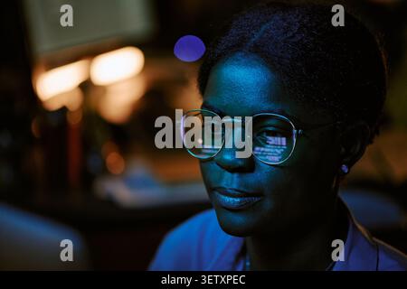 Black Woman Analyzing Data on Computer for Cybersecurity Work Stock Photo