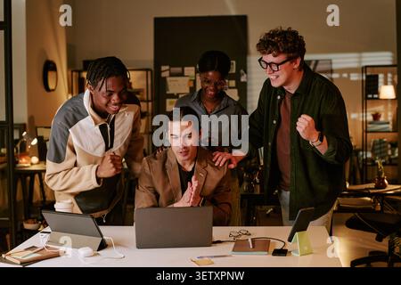 Diverse Coworkers Celebrating Success during Team Meeting Stock Photo