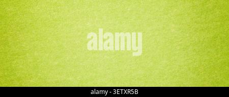 Light lime green suede fabric background with matte microfiber texture, soft pear felt surface with vignette in macro. Stock Photo
