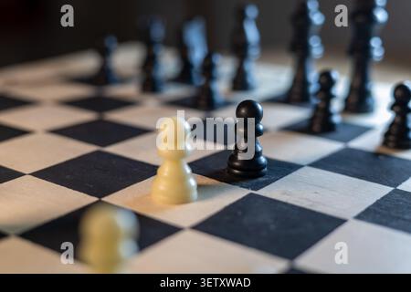 Black and White Chess Pawns Facing Each Other on Chessboard Stock Photo