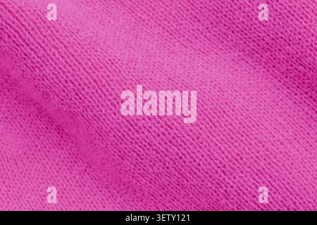 Macro shot full frame background of a vibrant pink knit fabric texture, highlighting the detailed interlaced stitches and soft ribbed pattern of the y Stock Photo