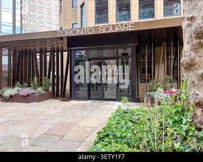 Modern office building entrance, Toronto Square, Leeds, UK. Exterior view showing glass doors, metallic architectural cladding, and stone paving. Stock Photo