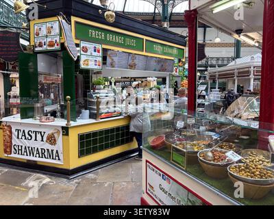 A food stall selling shawarma and olives inside Leeds City Markets, Leeds, UK. Stock Photo