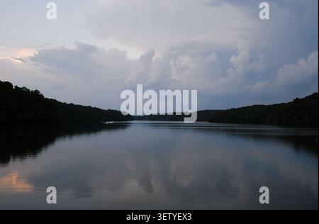 Dramatic storm clouds reflected on calm waters of Laurel Hill Lake in Lawrence County, Tennessee, USA. Stock Photo