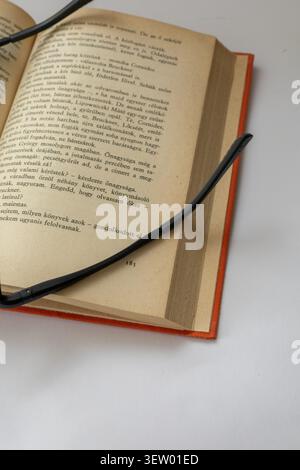 Antique Hungarian Book with Weathered Leather Cover and Aged Pages. Reading, read, glass, book Stock Photo