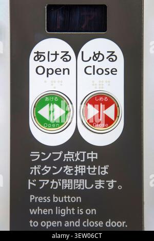 Kyoto, Japan - October 8, 2016: A close-up view of a bilingual elevator or train door control panel in Kyoto. Japanese transit and elevator controls a Stock Photo