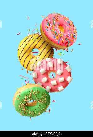 Sweet donuts and sprinkles falling on light blue background Stock Photo