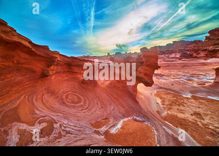Sandstone Formations and Swirling Patterns under Vibrant Sky in Little Finland Nevada Stock Photo
