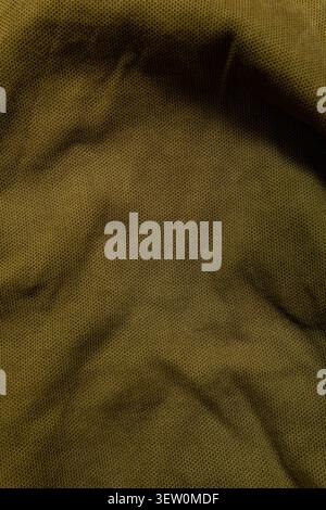 Close-up texture of olive green wrinkled canvas fabric. Stock Photo
